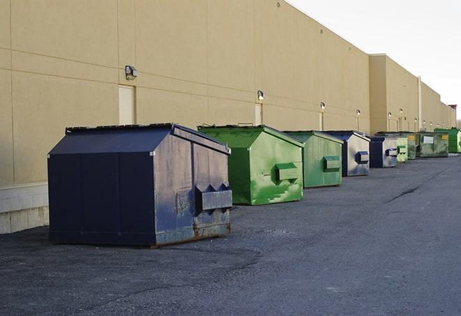 a group of dumpsters lined up along the street ready for use in a large-scale construction project in Omega, GA